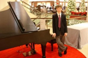 Eric Cameron beside a piano at Nordstrom's